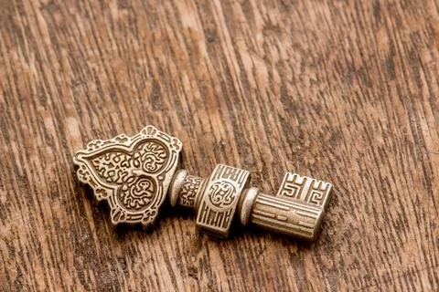 Decorated key  over a rustic background - center Stock Photos