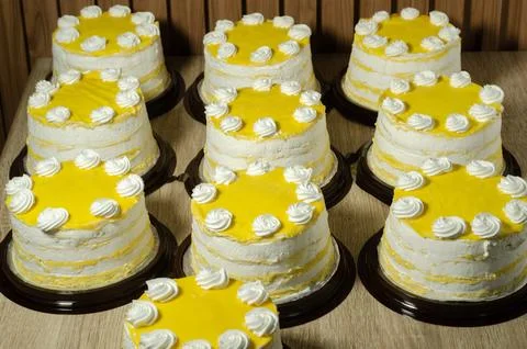 Decorated Layer Cake with White Frosting and Yellow Glaze Stock Photos