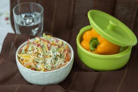 Decorated with lettuce, side view, selective focus . Orange pepper in a green Stock Photos