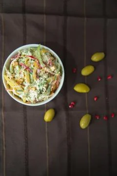 Decorated with lettuce, side view, selective focus . Orange pepper in a green Stock Photos