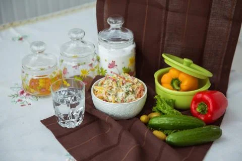 Decorated with lettuce, side view, selective focus . Orange pepper in a green Stock Photos