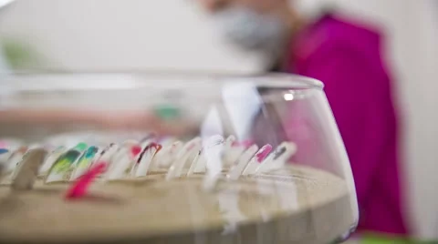 Decorated nails samples in sand while manicurist working Stock Footage 48597950