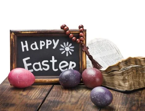 Decorated with painted easter eggs and an open bible wooden table Stock Photos