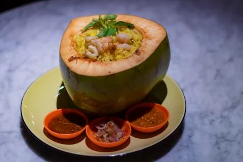 Decorated platter dinner with coconut shell fitted rice and sauce served in a Stock Photos