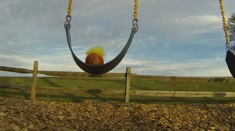 Decorated Pumpkin Swinging on Playground Stock Footage 59339454