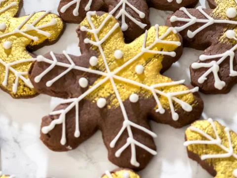 Decorated snowflake cookie with gold icing Stock Photos