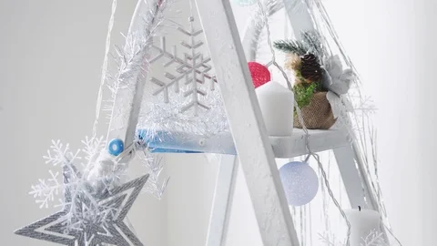Decorated stepladder in the new year style with pretty skates, snowflakes, stars Stock Footage 98767836