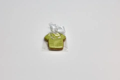 Decorated sugar cookie shaped as nurse's uniform wrapped in clear plastic bag Stock Photos