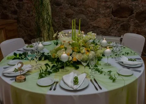 Decorated table with table compositions and burning candles Stock Photos