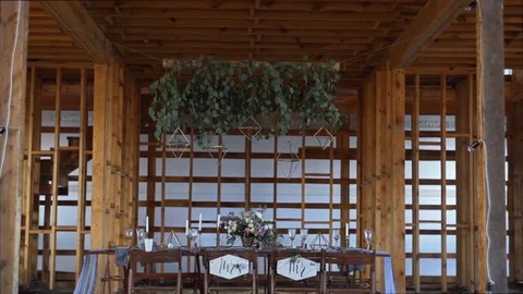 Decorated table for a wedding dinner in wooden building Stock Footage 82208239