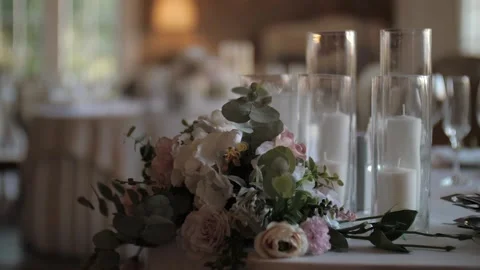 Decorated table for wedding reception with flower arrangement and candles Stock Footage 131009719