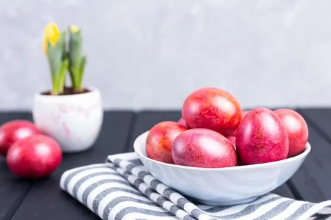 Decorated traditional Easter eggs in ceramic plate black wooden background Stock Photos
