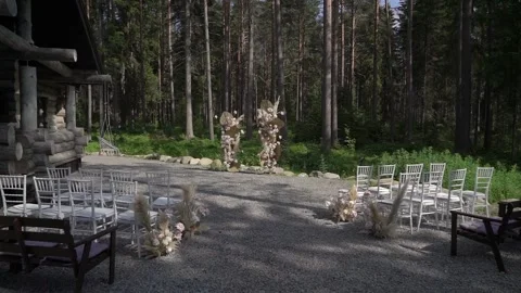 Decorated wedding ceremony outside. Arch with dry grass, white and pink flowers. Stock Footage 166590104