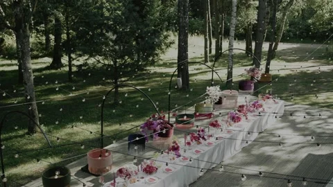 Decorated wedding table with bright flowers in the wood Stock Footage 232485991