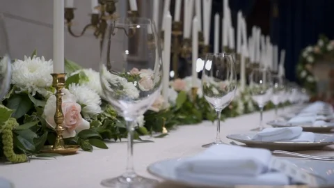 Decorated wedding table with with flowers  and glasses in the restaurant Stock Footage 105003546