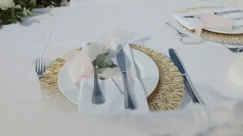 Decorated wedding table with with flowers  and glasses on the summer terrace Stock Footage 115435701
