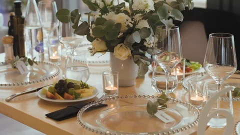 Decorated wedding table with with glasses of wine and meals at dishes Stock Footage 113543176