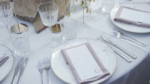 Decorated wedding table, plates with invitation, candles and flowers 動画素材 220534250