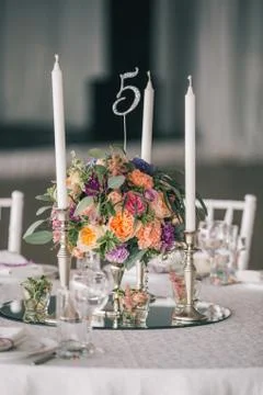 Decorated Wedding table setting with candles and flowers Stock Photos