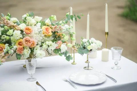Decorated wedding table for two with beautiful flower composition, glasses for Stock Photos
