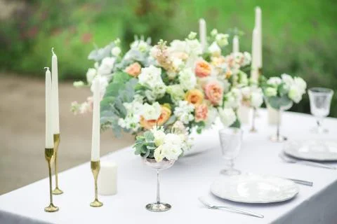 Decorated wedding table for two with beautiful flower composition, glasses for Stock Photos