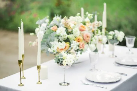 Decorated wedding table for two with beautiful flower composition, glasses for Photos