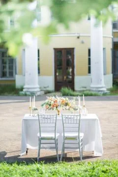 Decorated wedding table for two with beautiful flower composition, glasses for Stock Photos