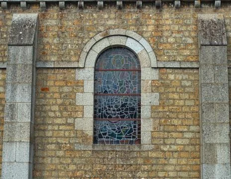Decorated window on stone bricks wall at cathedral Stock Photos