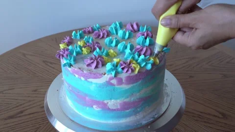 Decorates cake squeezes cream out Stock Footage 156621939