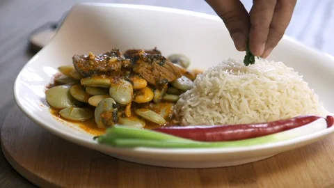 Decorating bean stew dish cooked with beef and served with rice Stock Footage 122449494