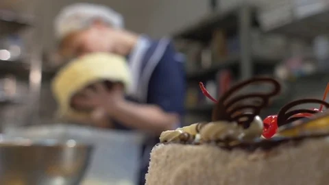 Decorating birthday cake at bakery Video stock 71804895