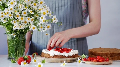 Decorating biscuit with cream and strawberries Stock Footage 102932005