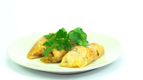 Decorating cabbage rolls with parsley in slow motion. Stock Footage 86894130