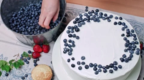 Decorating cake with blueberry Stock Footage 68019630
