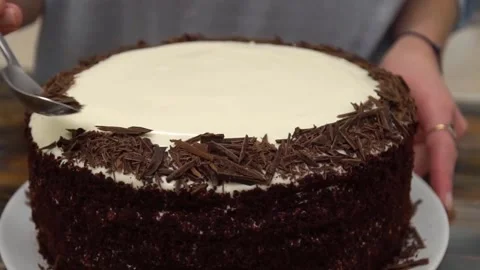 Decorating the cake with chocolate chips Stock Footage 155298607