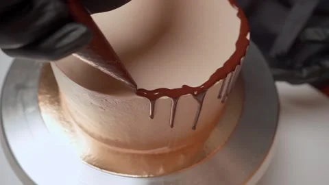 Decorating the cake with chocolate with drops with a pastry bag. Top view Video stock 153462431