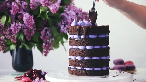 Decorating cake with cream cones and chocolate liquid coating. Stock Footage 102042608