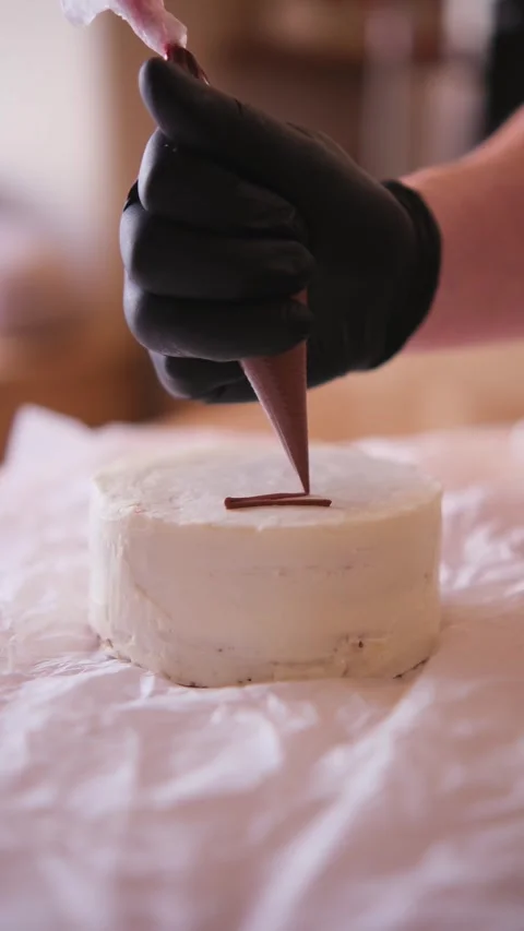 Decorating a cake with cream Stock Footage 309954041