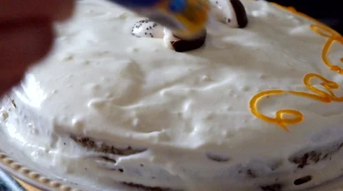Decorating cake with orange icing, selective focus Stock Footage
