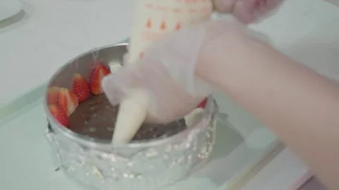 Decorating a Cake with Strawberry Toppings Stock Footage 313880292