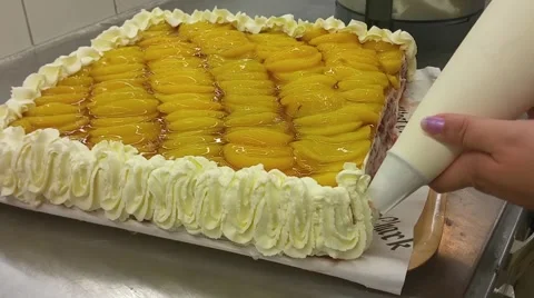 Decorating a cake with whipped cream, at a bakery restaurant Stock Footage 55571753