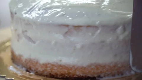 Decorating cake wth white cream Stock Footage 120607658