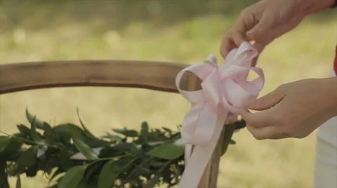 Decorating the chairs before the wedding Stock Footage 53866327
