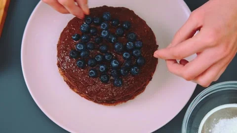 Decorating a chocolate cake with blueberries Stock Footage 252489856