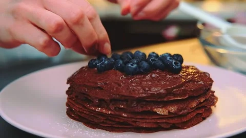 Decorating a chocolate cake with blueberries Stock Footage 252542165