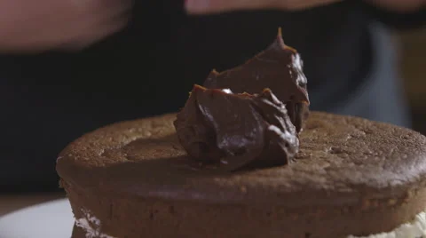Decorating a chocolate cake with ganache Stock Footage 64049069