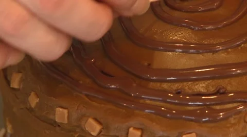 Decorating a chocolate cake with icong Stock Footage 55197710