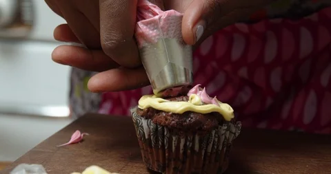 Decorating a chocolate cupcake Stock Footage 117018132
