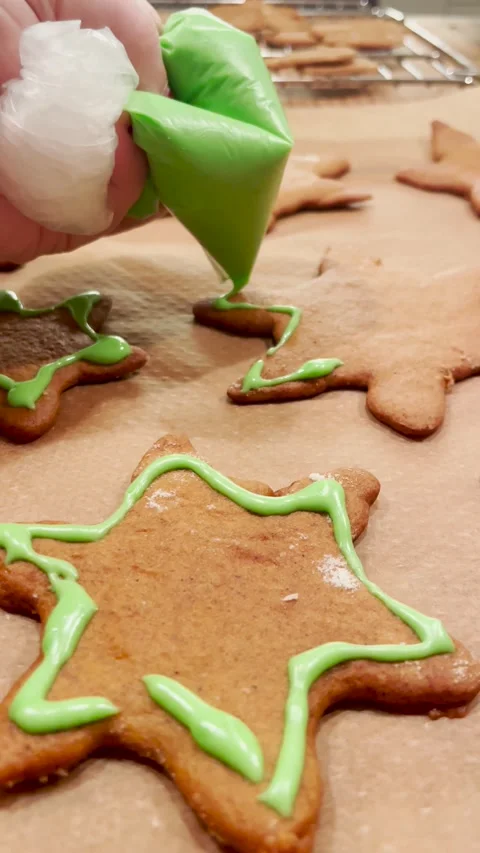 Decorating Christmas gingerbread cookies with icing Stock Footage 208157162