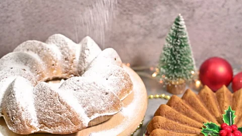 Decorating a Christmas Gugelhupf Cake with a Dusting of Powdered Sugar Stock Footage 255338046